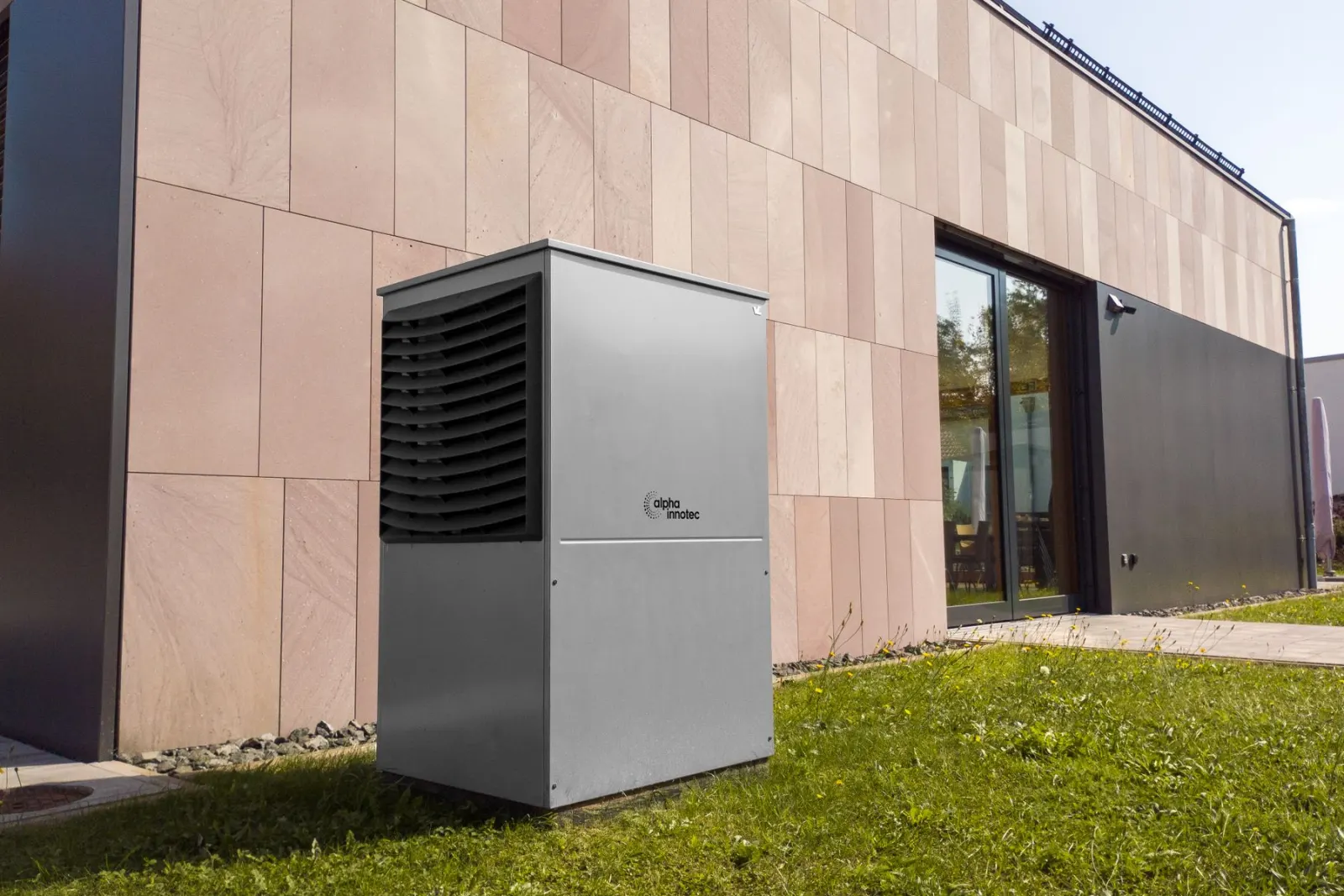 An outdoor unit standing against the side of a building