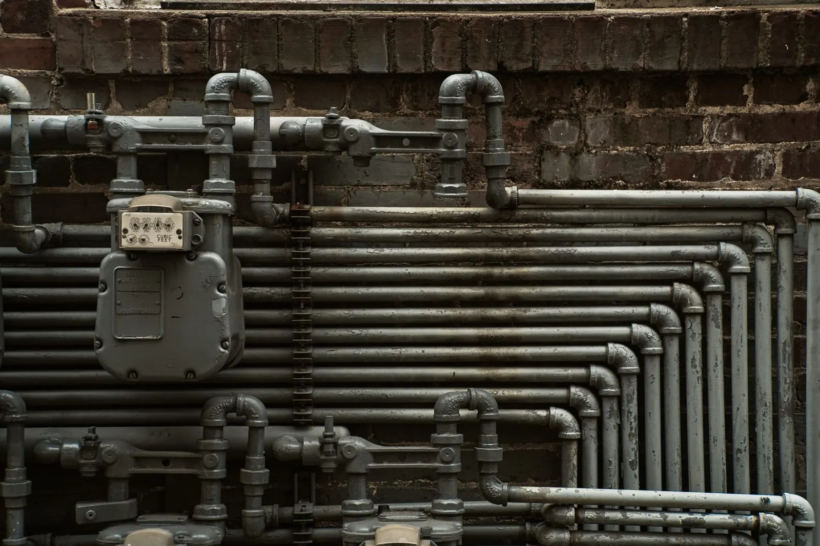 A bank of heating pipes running along a wall