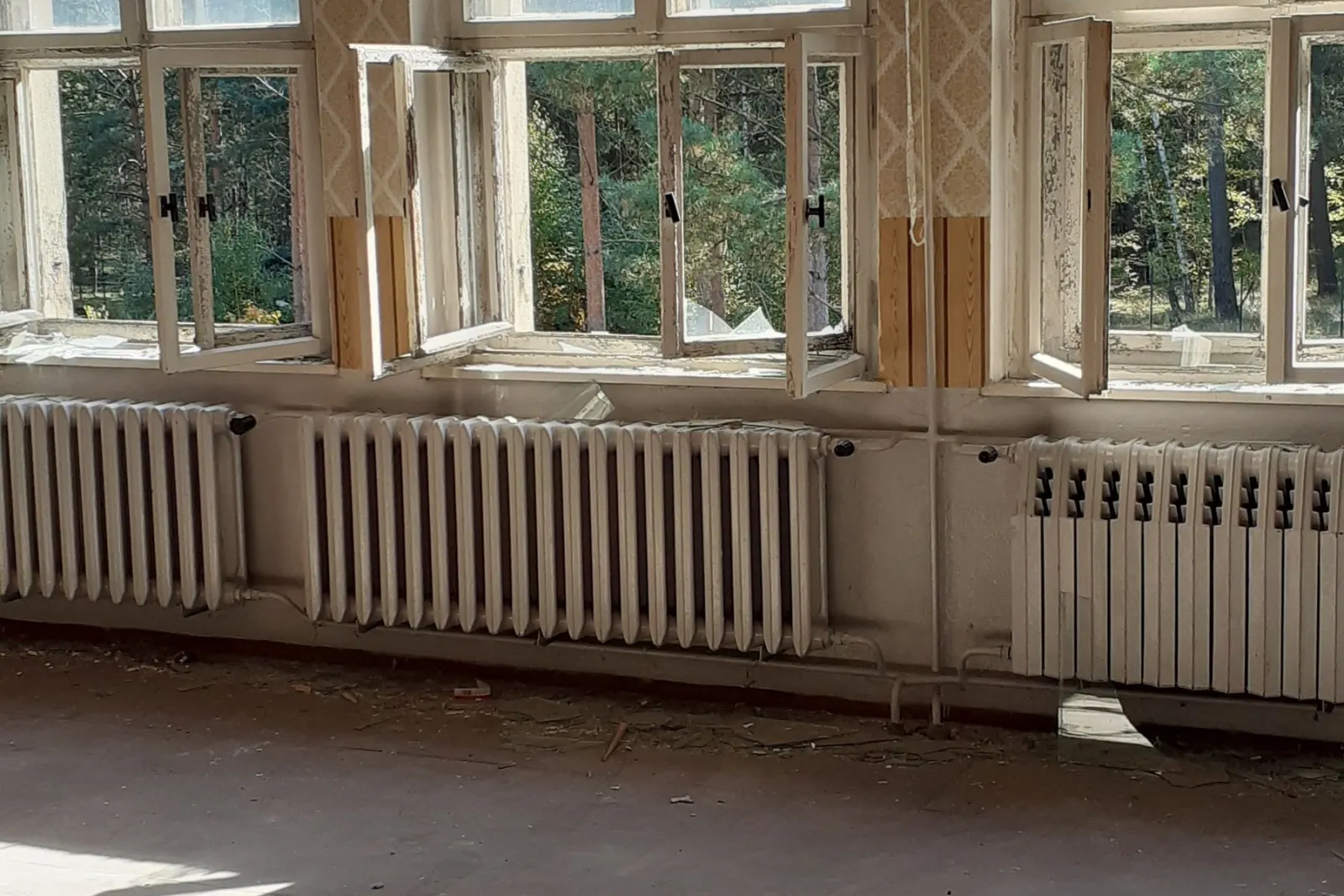 Radiators running under a row of tall windows